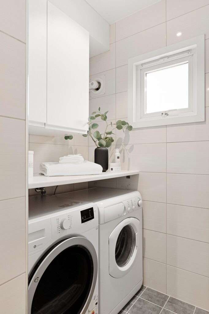 "Commercial laundry team handling linen and uniforms in a modern facility."