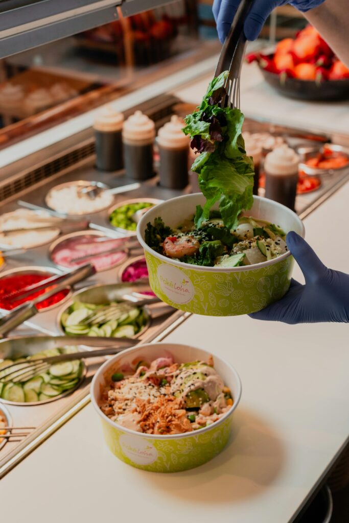"Catering staff serving freshly prepared meals in a corporate dining setup."