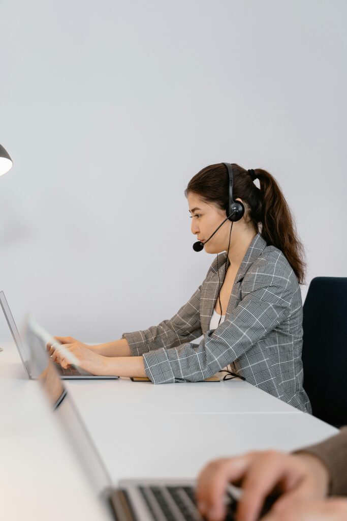 "Hospitality support staff assisting guests at a luxury hotel front desk."